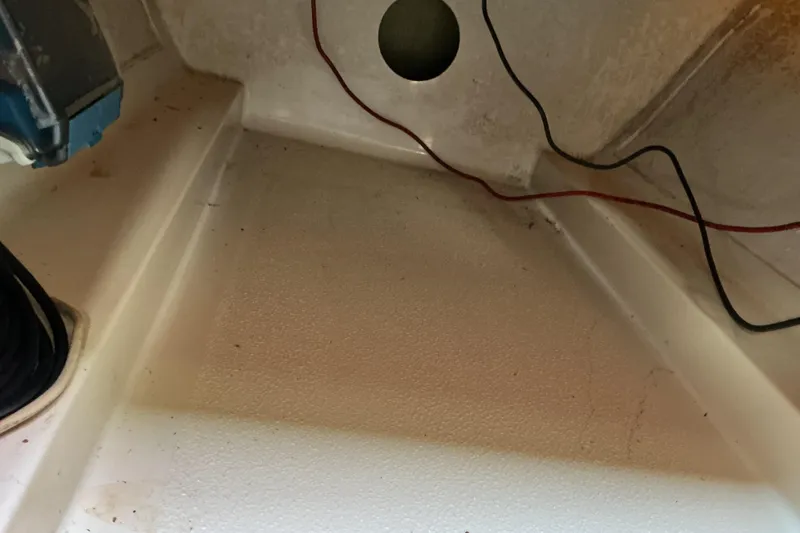 Slide: The Image of Interior view of a 1992 Dragonfly 800 Swing Wing boat showing wiring and compartment details. - 36