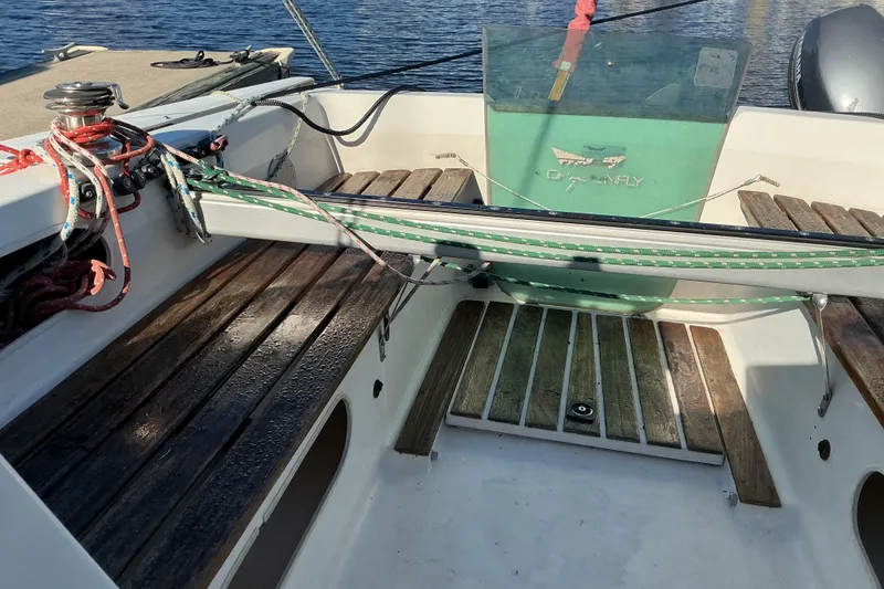 Slide: The Image of Cockpit of a 1992 Dragonfly 800 Swing Wing sailboat with wooden seating and rigging. - 37