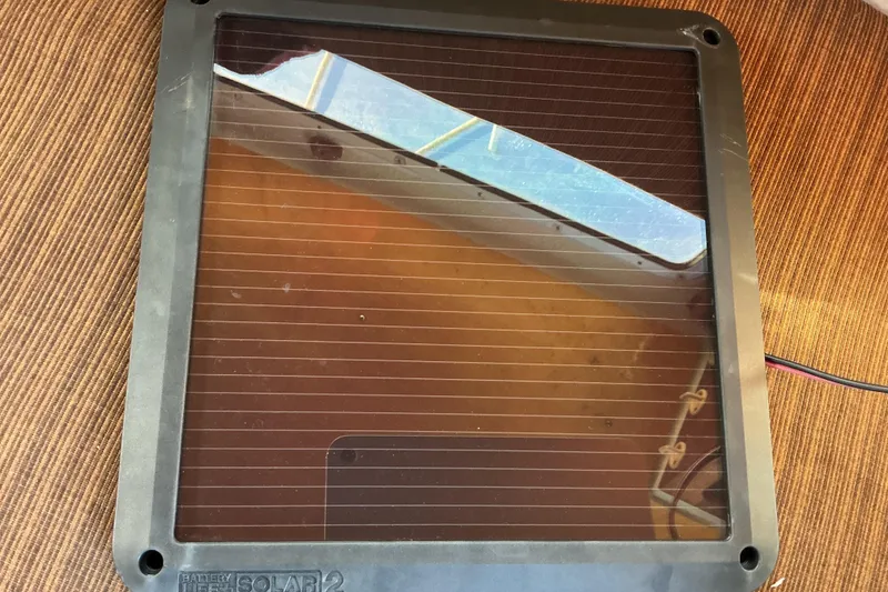 Slide: The Image of 1992 Dragonfly 800 Swing Wing solar panel on a wooden surface. - 39