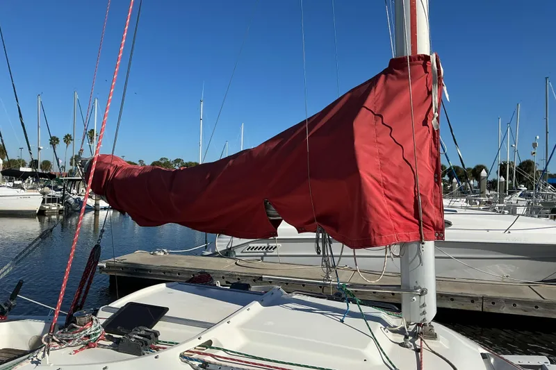Slide: The Image of Sailboat with red sail cover docked at marina, Dragonfly 800 Swing Wing, 1992 model. - 41