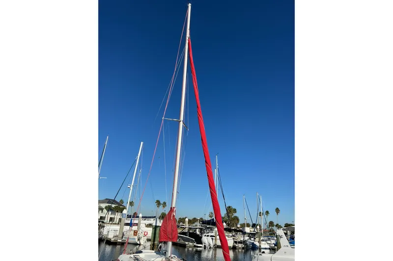 Slide: The Image of Sailboat in marina, Dragonfly 800 Swing Wing, 1992 model, with red sail cover. - 45