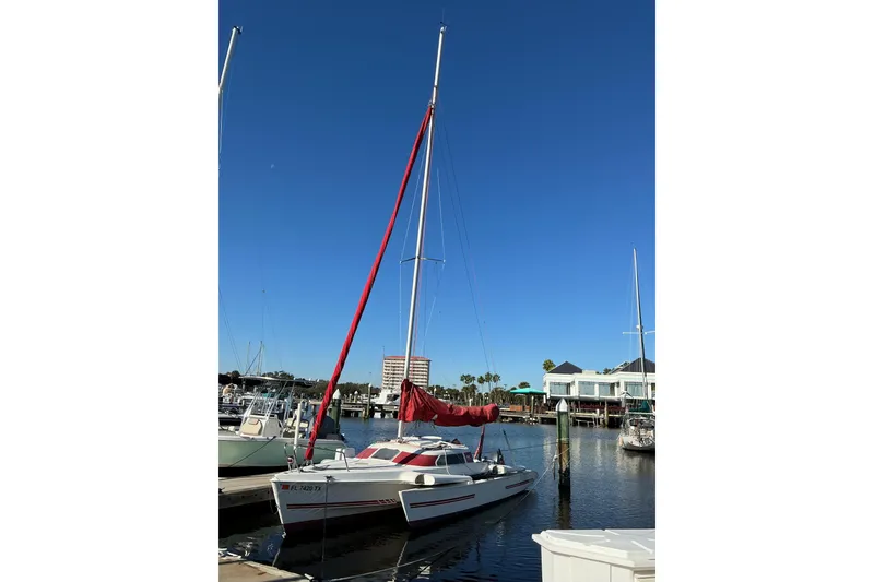 Slide: The Image of Sailboat docked in marina, Dragonfly 800 Swing Wing, 1992 model, clear blue sky. - 50