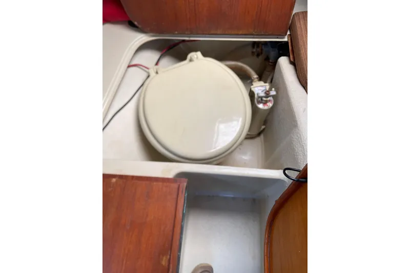 Slide: The Image of Boat toilet in a 1992 Dragonfly 800 Swing Wing, with wooden cabinetry. - 54