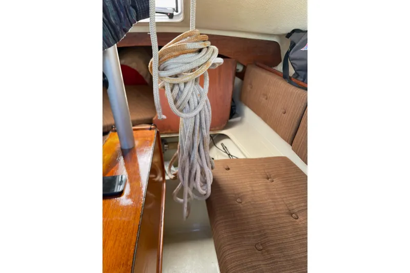 Slide: The Image of Interior of a 1992 Dragonfly 800 Swing Wing sailboat with coiled rope and seating. - 55