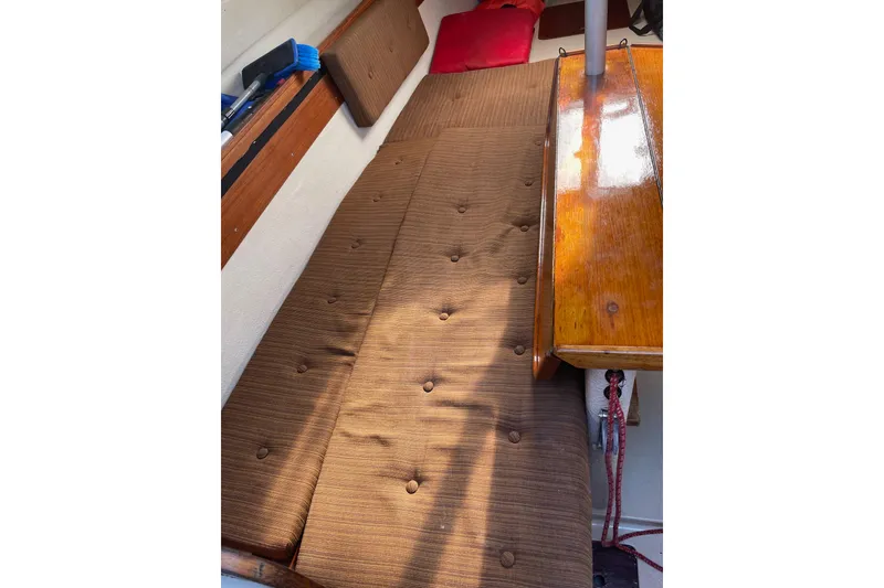 Slide: The Image of Brown cushioned seating inside a 1992 Dragonfly 800 Swing Wing boat cabin. - 6