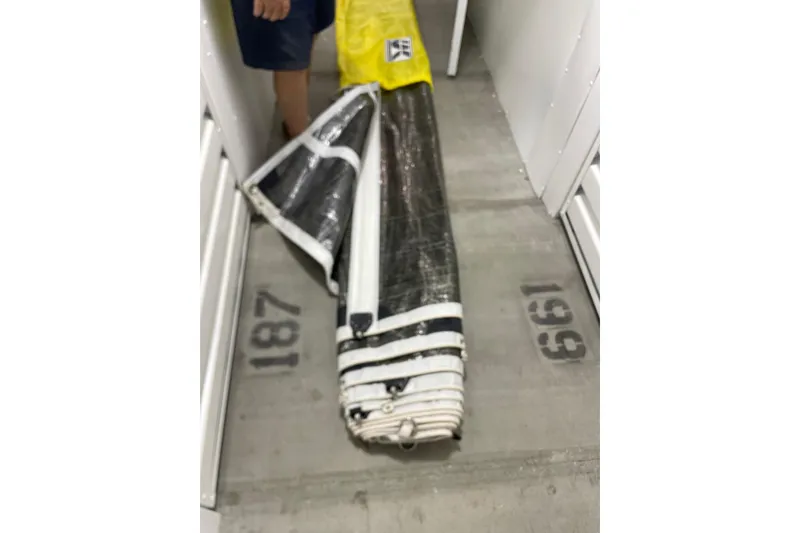 Slide: The Image of Rolled sail from a 1992 Dragonfly 800 Swing Wing, stored in a narrow space. - 61