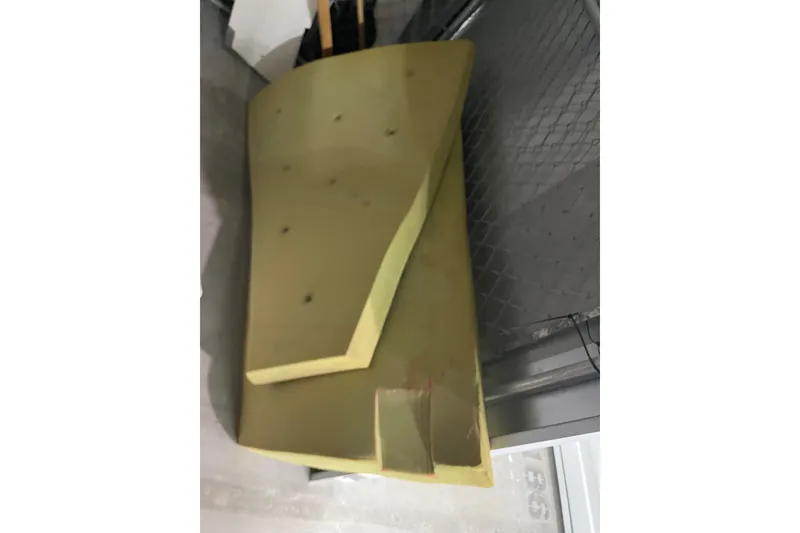 Slide: The Image of Yellow foam seat cushion for Dragonfly 800 Swing Wing, 1992 model, leaning against a fence. - 62