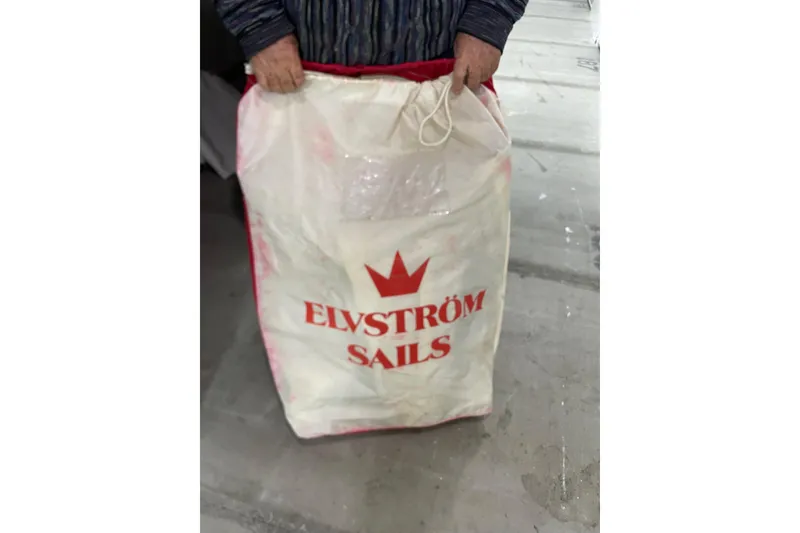 Slide: The Image of Man holding Elvstrøm Sails bag, associated with Dragonfly 800 Swing Wing, 1992 model. - 64