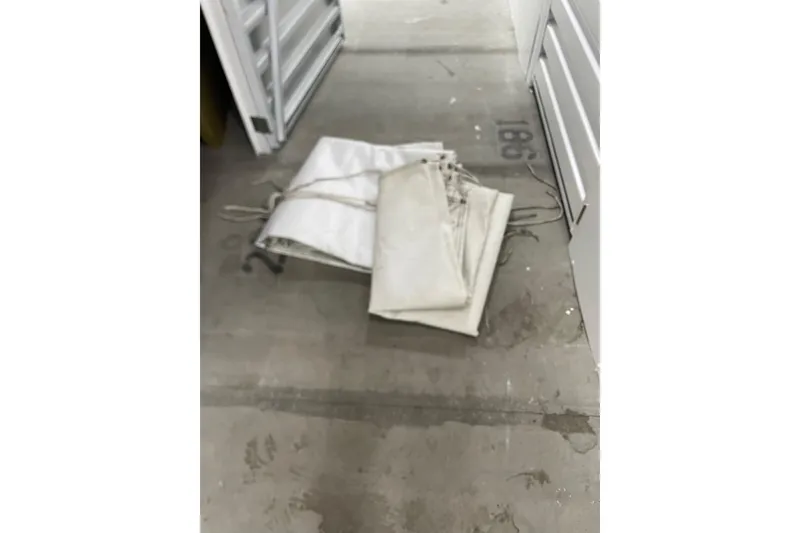 Slide: The Image of Folded white sails on concrete floor near storage unit, Dragonfly 800 Swing Wing, 1992. - 66