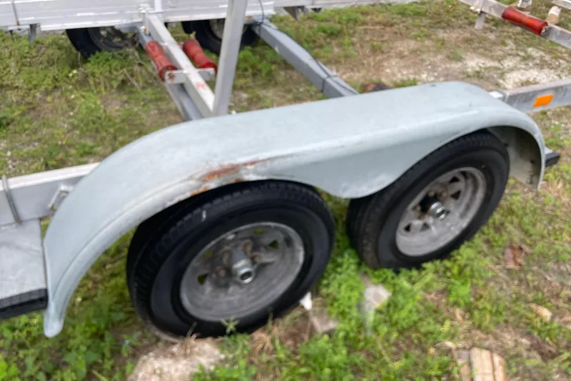 Slide: The Image of Trailer wheels of a 1992 Dragonfly 800 Swing Wing on grassy ground. - 71