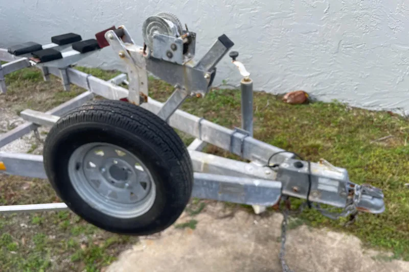 Slide: The Image of Trailer hitch and wheel of 1992 Dragonfly 800 Swing Wing on grass. - 75