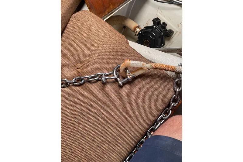 Slide: The Image of Chain and rope secured on a brown cushion, near a mechanical component. Dragonfly 800 Swing Wing, 1992. - 9