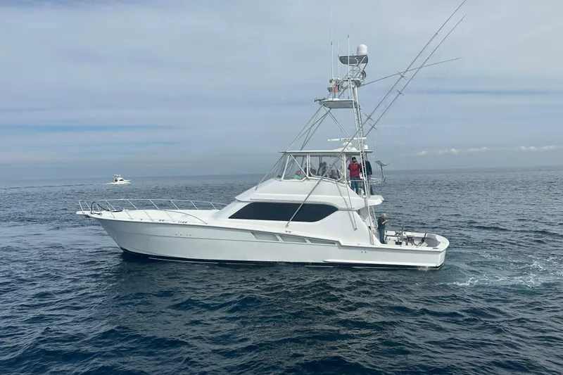 Slide: The Image of 2000 Hatteras 60 yacht cruising on open sea. - 1