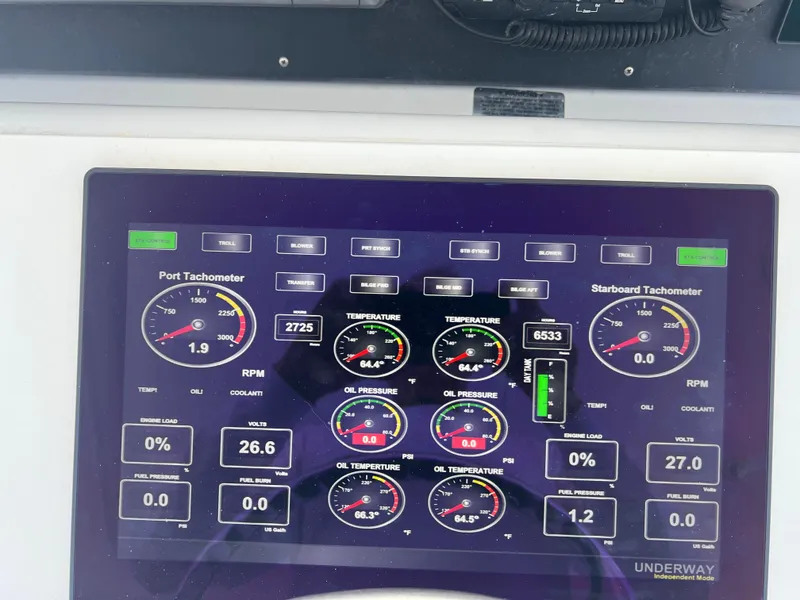 Slide: The Image of Control panel of a 2000 Hatteras 60 yacht displaying engine metrics and tachometers. - 10