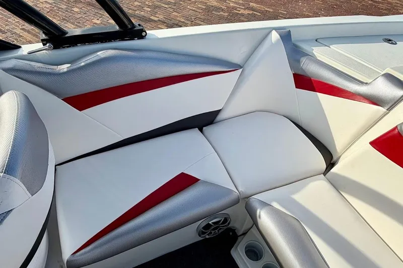 Slide: The Image of 2012 Tigé R20 boat interior with red and silver accents, featuring comfortable seating. - 14