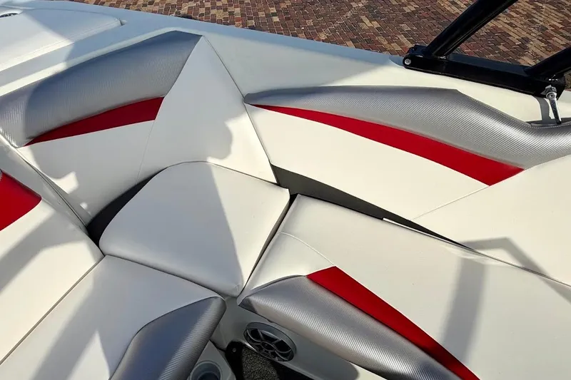 Slide: The Image of 2012 Tigé R20 boat interior with red, white, and gray seating design. - 16