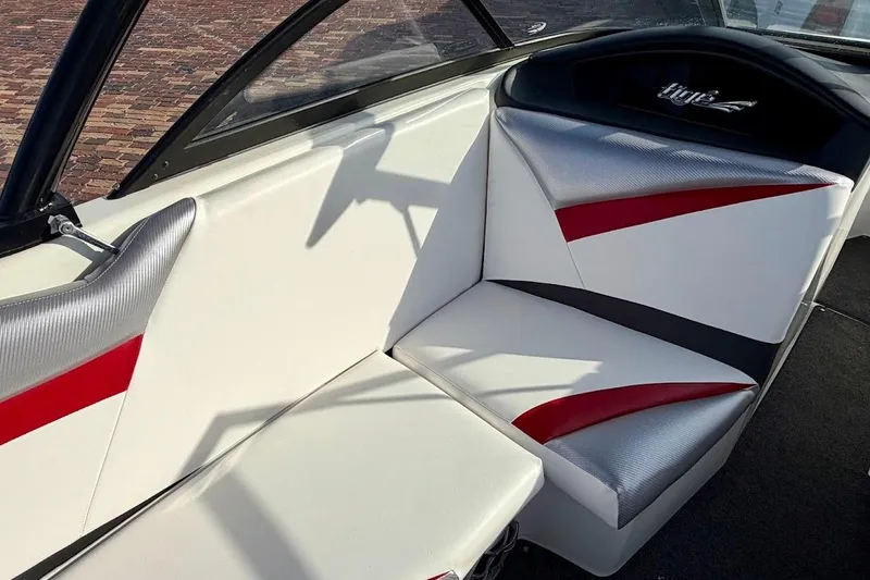 Slide: The Image of Interior of 2012 Tigé R20 boat with white, red, and silver seating. - 17