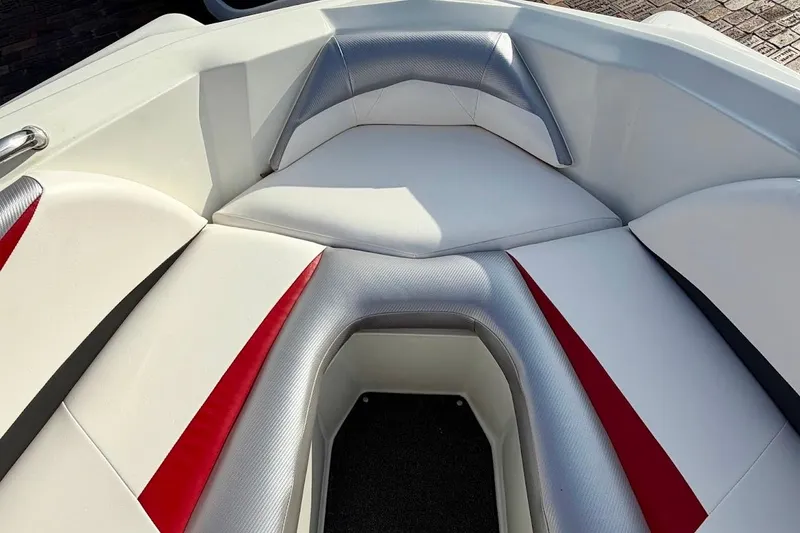 Slide: The Image of 2012 Tigé R20 boat interior with white, red, and gray seating. - 19
