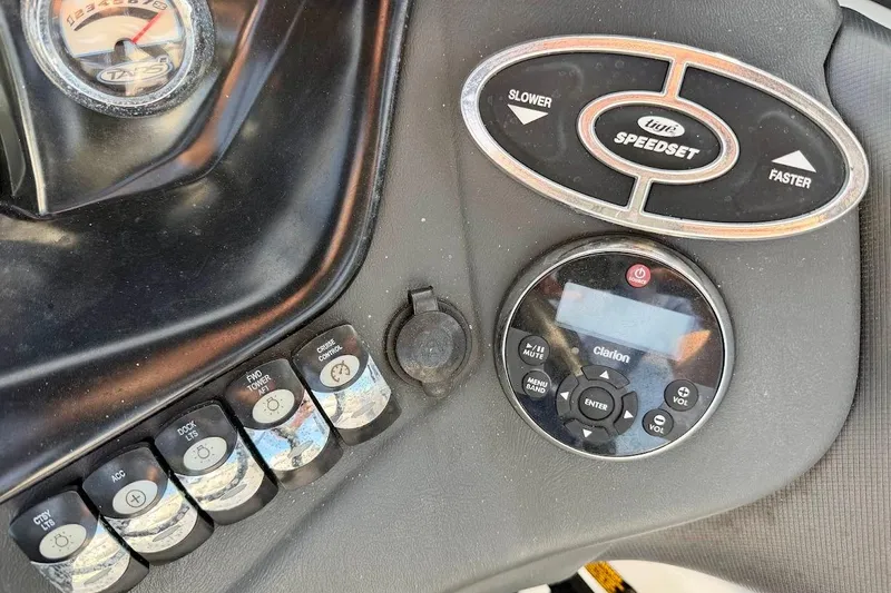 Slide: The Image of Control panel of a 2012 Tigé R20 boat with speed and audio settings. - 26