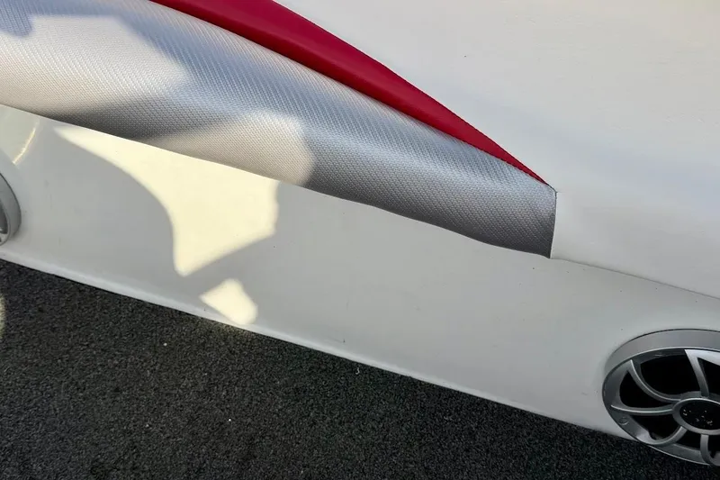 Slide: The Image of 2012 Tigé R20 boat interior detail with red and gray upholstery and speaker. - 29