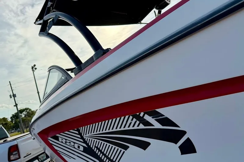 Slide: The Image of 2012 Tigé R20 boat with sleek design and bold graphics, parked outdoors. - 9