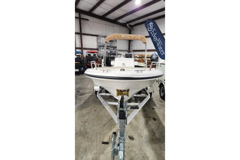 Slide: The Image of 2024 Edgewater 158CS boat on trailer in indoor storage facility. - 1