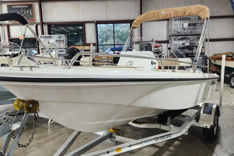 Slide: The Image of 2024 Edgewater 158CS boat on trailer in showroom, featuring Yamaha equipment. - 2