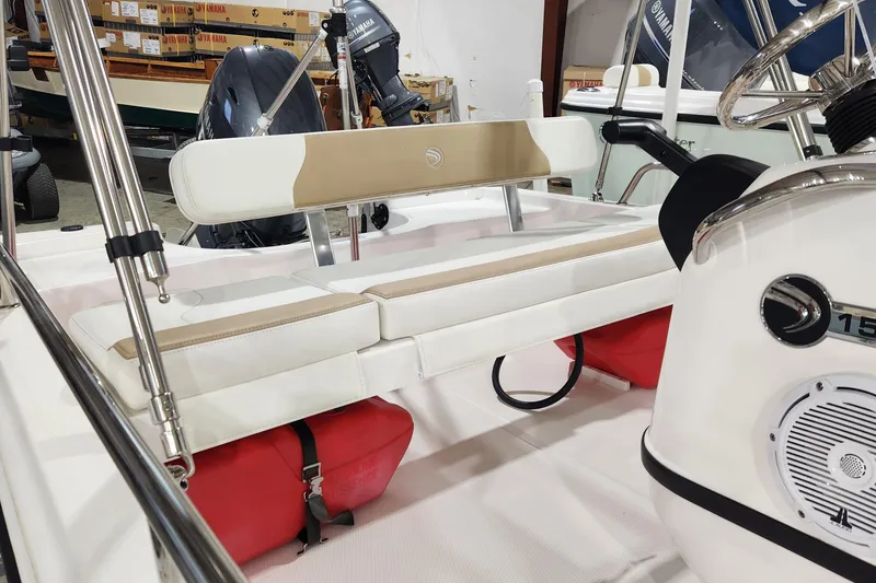 Slide: The Image of 2024 Edgewater 158CS boat interior with seating and Yamaha engine in showroom. - 4