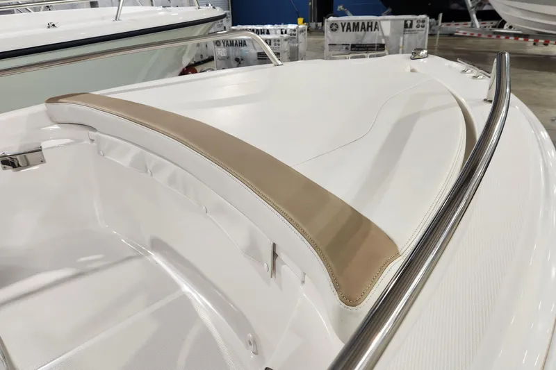 Slide: The Image of 2024 Edgewater 158CS boat interior with beige seating and stainless steel railing. - 7