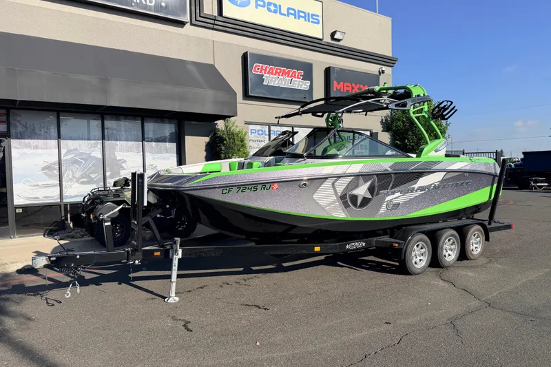 The Image of 2014 Nautique Super Air Nautique G23 boat on trailer outside dealership. - 0