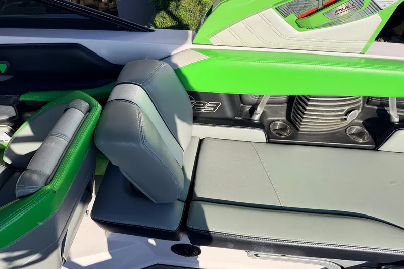 Slide: The Image of 2014 Nautique Super Air Nautique G23 interior with green and gray seating. - 10