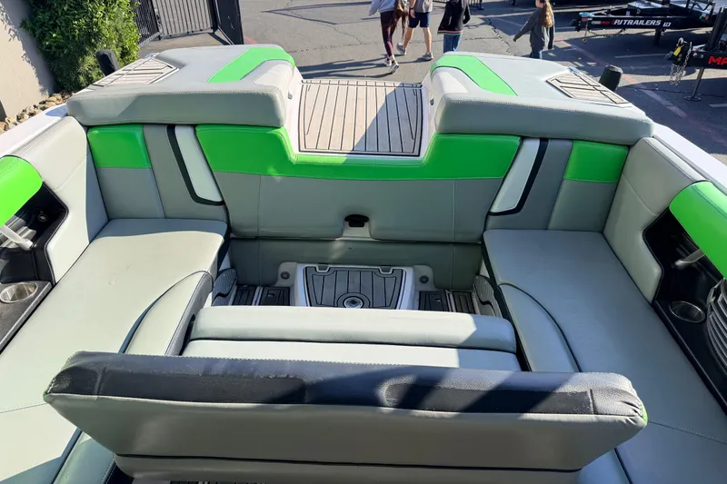 Slide: The Image of 2014 Nautique Super Air Nautique G23 interior with green accents and spacious seating. - 13