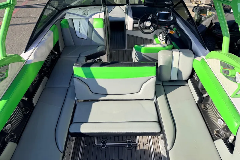 Slide: The Image of 2014 Nautique Super Air Nautique G23 interior with green and gray seating. - 14
