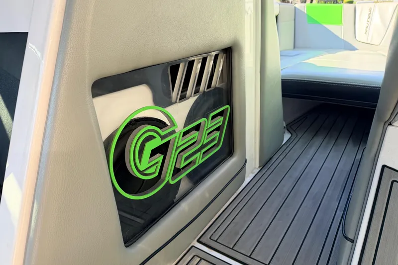 Slide: The Image of 2014 Nautique Super Air Nautique G23 interior with green G23 logo and seating. - 21