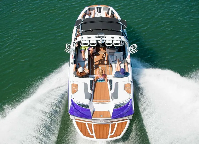 Slide: The Image of 2014 Nautique Super Air Nautique G23 boat on trailer, rear view, vibrant green color. - 3