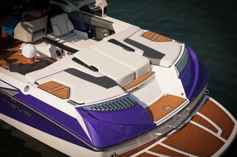 Slide: The Image of 2014 Nautique Super Air Nautique G23 boat on trailer, vibrant green and gray design. - 5