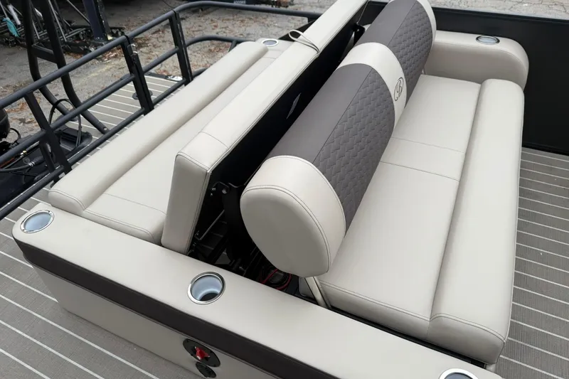 Slide: The Image of 2026 Bentley Pontoons Elite 223 Swingback seating with beige upholstery and cup holders. - 10
