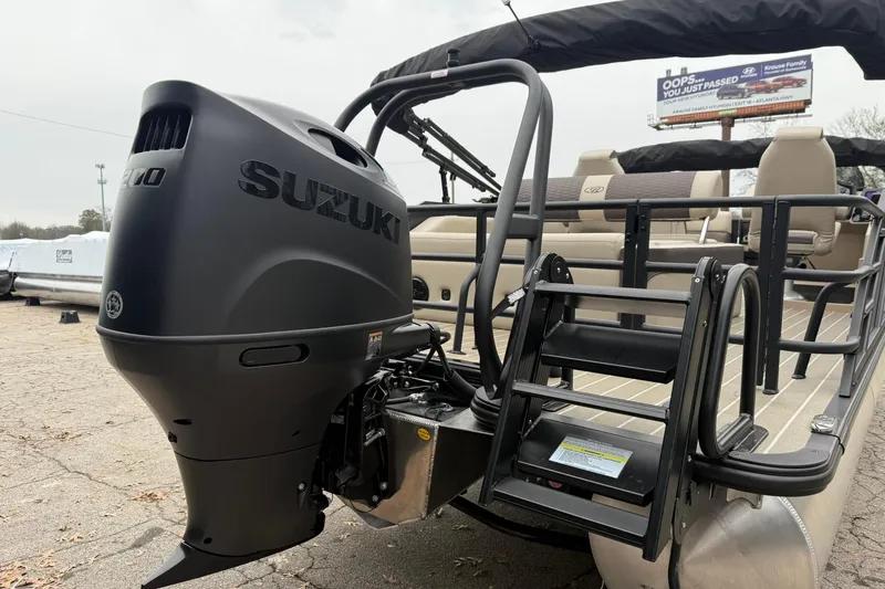 Slide: The Image of 2026 Bentley Pontoons Elite 223 Swingback with Suzuki outboard motor, rear view. - 12