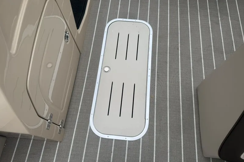 Slide: The Image of 2026 Bentley Pontoons Elite 223 Swingback deck with storage hatch and striped flooring. - 15