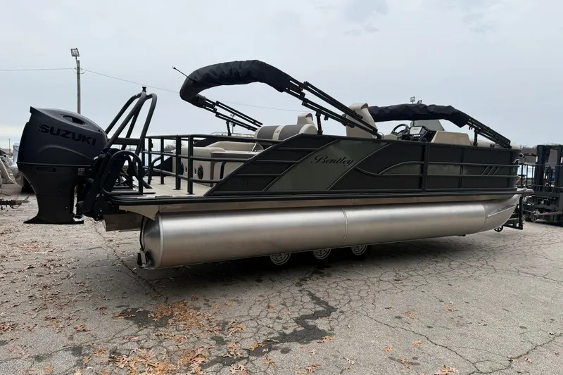 Slide: The Image of 2026 Bentley Pontoons Elite 223 Swingback with Suzuki engine, parked on cracked pavement. - 4