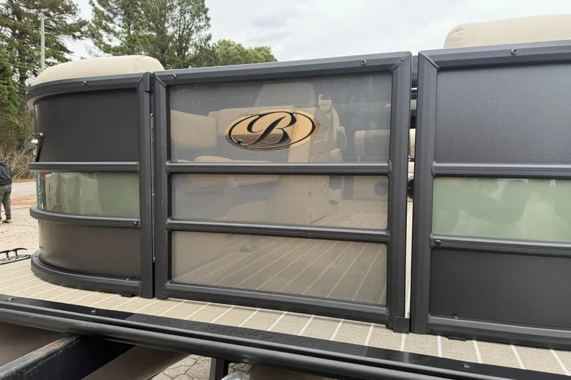 Slide: The Image of 2026 Bentley Pontoons Elite 223 Swingback, sleek design with logo, docked outdoors. - 5