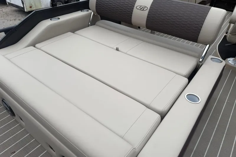 Slide: The Image of 2026 Bentley Pontoons Elite 223 Swingback with luxurious beige seating and cup holders. - 9