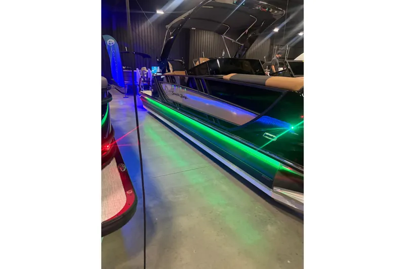 Slide: The Image of 2026 South Bay Sport RS9 DC boat with vibrant LED lighting display. - 2