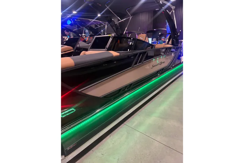 Slide: The Image of 2026 South Bay Sport RS9 DC boat with sleek design and vibrant LED lights. - 3
