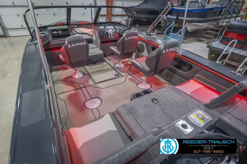 Slide: The Image of 2026 Lund 1875 Crossover XS boat interior with modern dashboard and seating. - 15