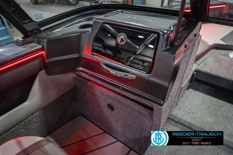 Slide: The Image of Interior view of 2026 Lund 1875 Crossover XS boat with carpeted flooring and storage compartments. - 24