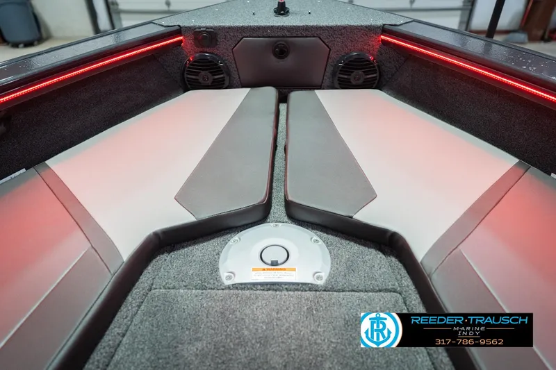 Slide: The Image of 2026 Lund 1875 Crossover XS boat interior with storage compartments and red LED lighting. - 28