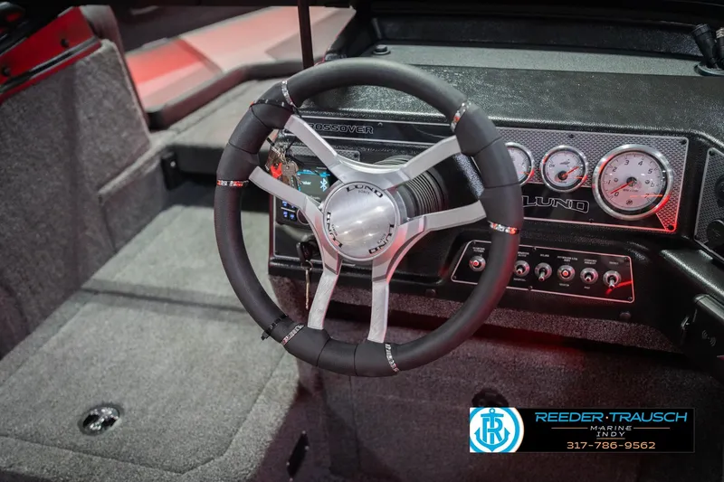 Slide: The Image of Steering wheel of 2026 Lund 1875 Crossover XS boat, featuring sleek metallic design. - 31