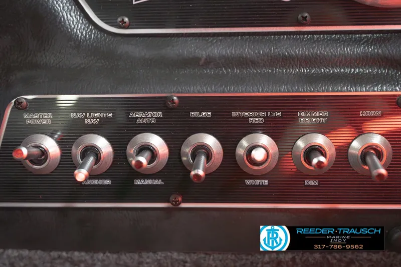 Slide: The Image of 2026 Lund 1875 Crossover XS boat interior with red LED lighting and control lever. - 36