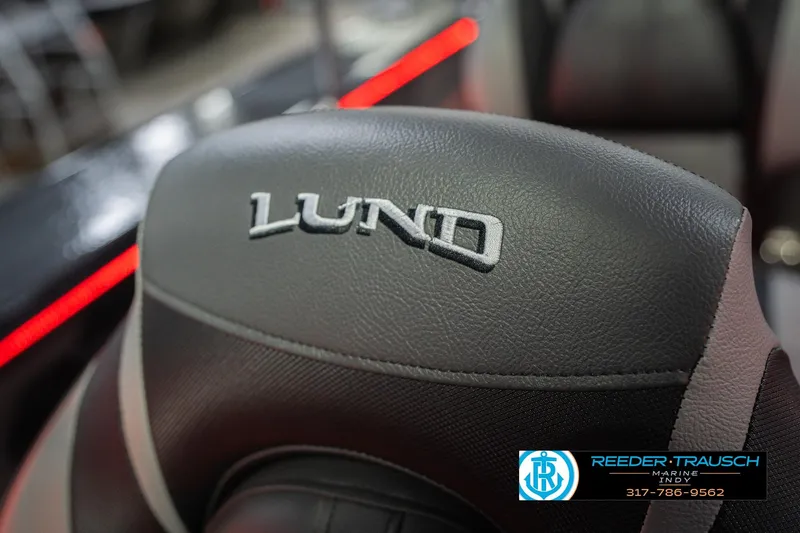 Slide: The Image of 2026 Lund 1875 Crossover XS boat seat with red LED lighting, Reeder-Trausch Marine logo. - 40